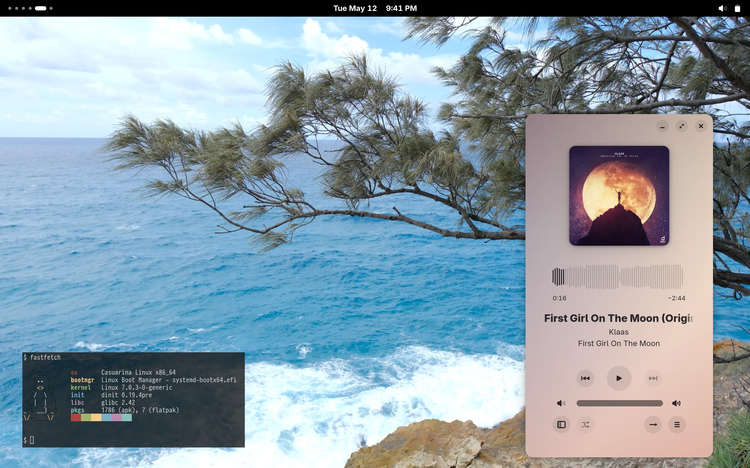Casuarina Linux GNOME desktop with a music player open and compact fastfetch output showing OS: Casuarina Linux x86, boot manager: systemd-boot, kernel: Linux, init: dinit, libc: glibc, pkgs: apk (1786)